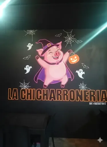 There is a sign that says la chicharroniaria with a pig in a witch costume